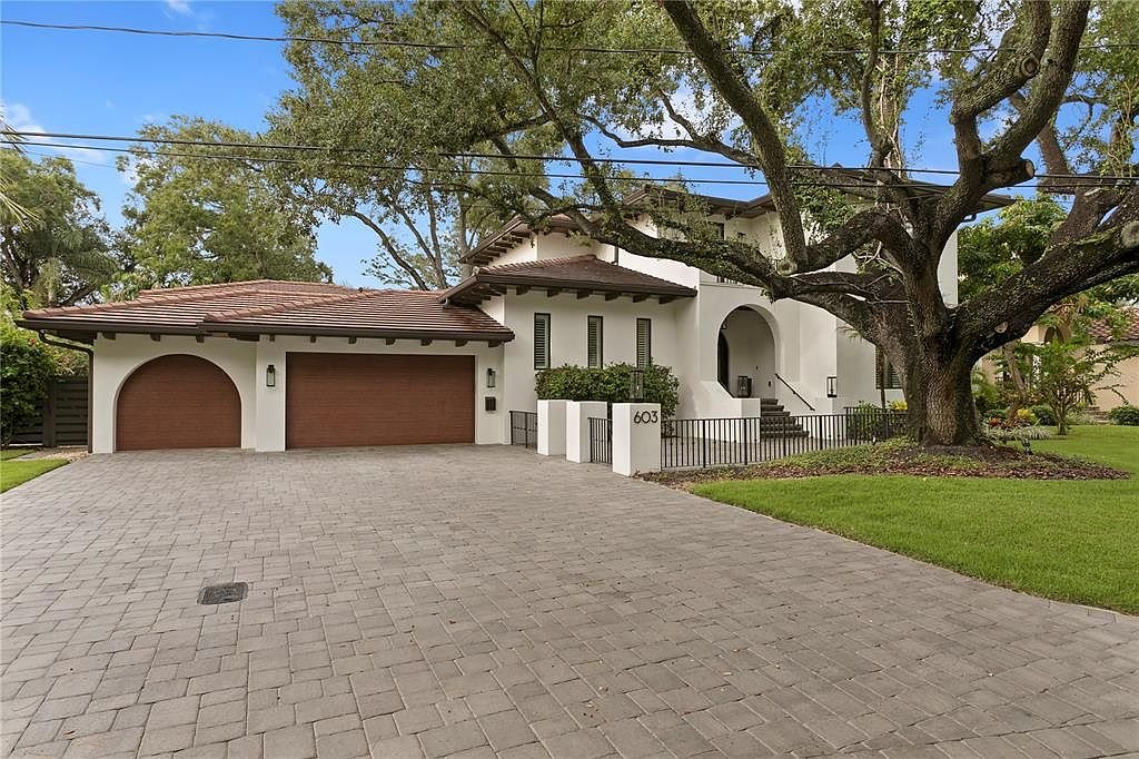 Mediterranean canal home with putting green